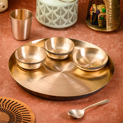 Elegant brass serving tray with three bowls and decorative items, perfect for festive occasions.